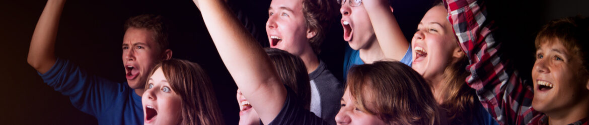 Ecstatic teens celebrating at a concert or event.